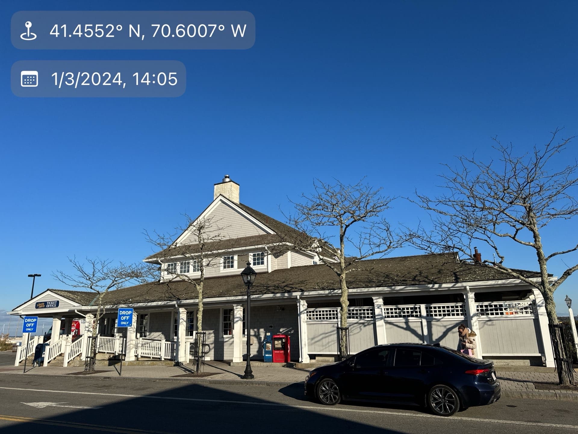 2024-01-03 19 05 59Z-lqy5fj03l2hmun5k Gray shingle building exterior with a drop-off zone and a dark car parked in front.