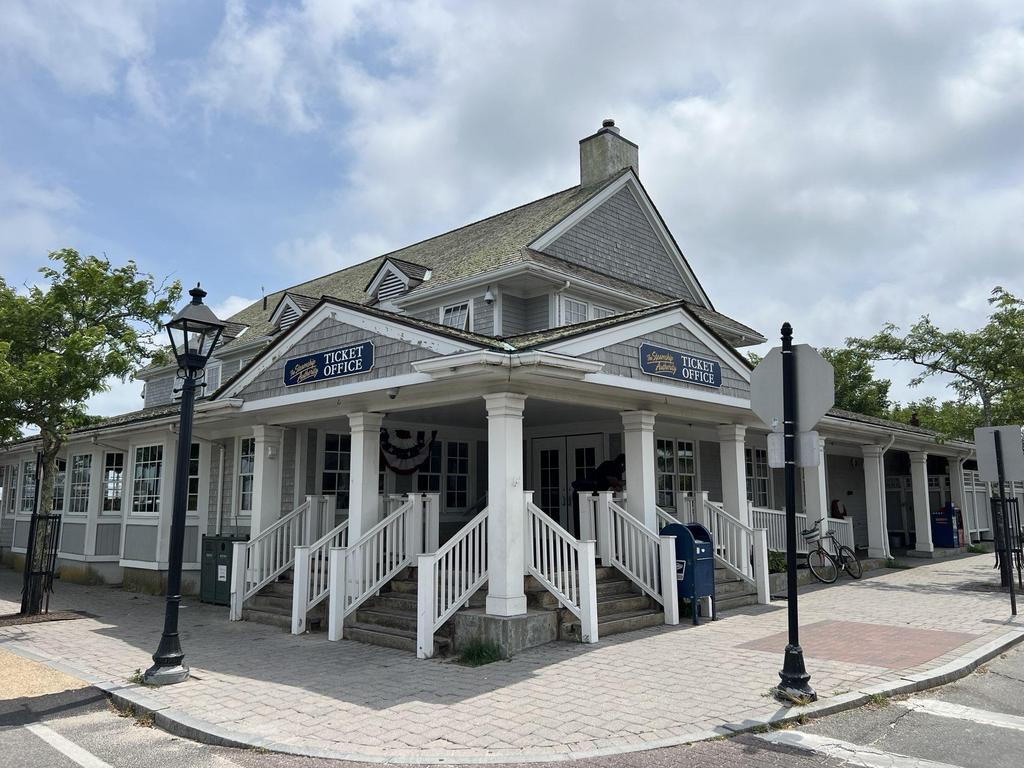 7 28 2023 16 51 19-lkn26jt54rdieqx4 Gray shingle building with a covered porch and Ticket Office signs.