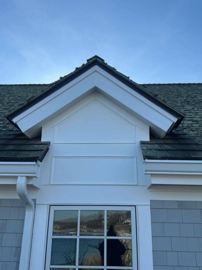 PHOTO-2023-12-16-09-59-03-lqa6z8wx50xi7xnd Dormer with white trim and gray shingle siding below the roofline.