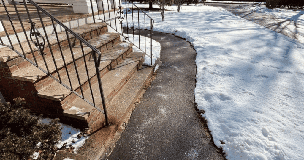 Photo of a cleared walkway after a snow storm. 