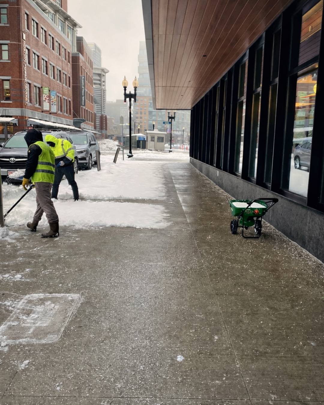 Commercial snow plowing in Woburn. Photo of FRG Contractor clearing snow from a sidewalk.